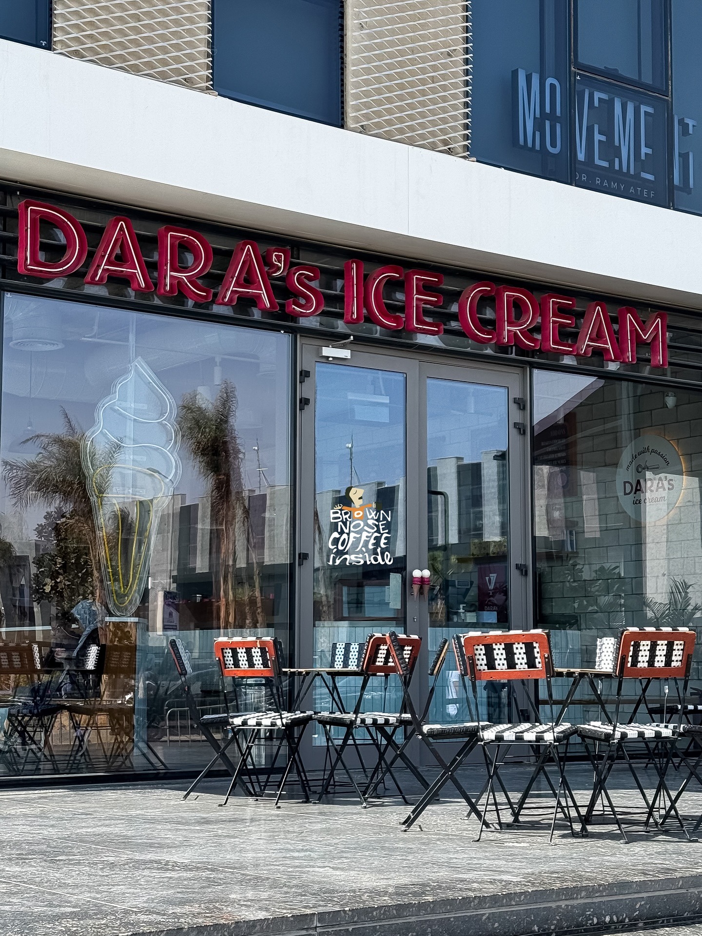 The Dara's shopfront, with its red neon sign